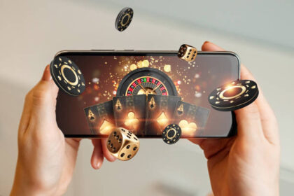 creative-background-online-casino-in-a-mans-hand-a-smartphone-with-playing-cards-roulette-and